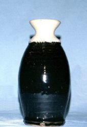 John bedding Tenmoku and ash glaze vase made at the Leach pottery 1975